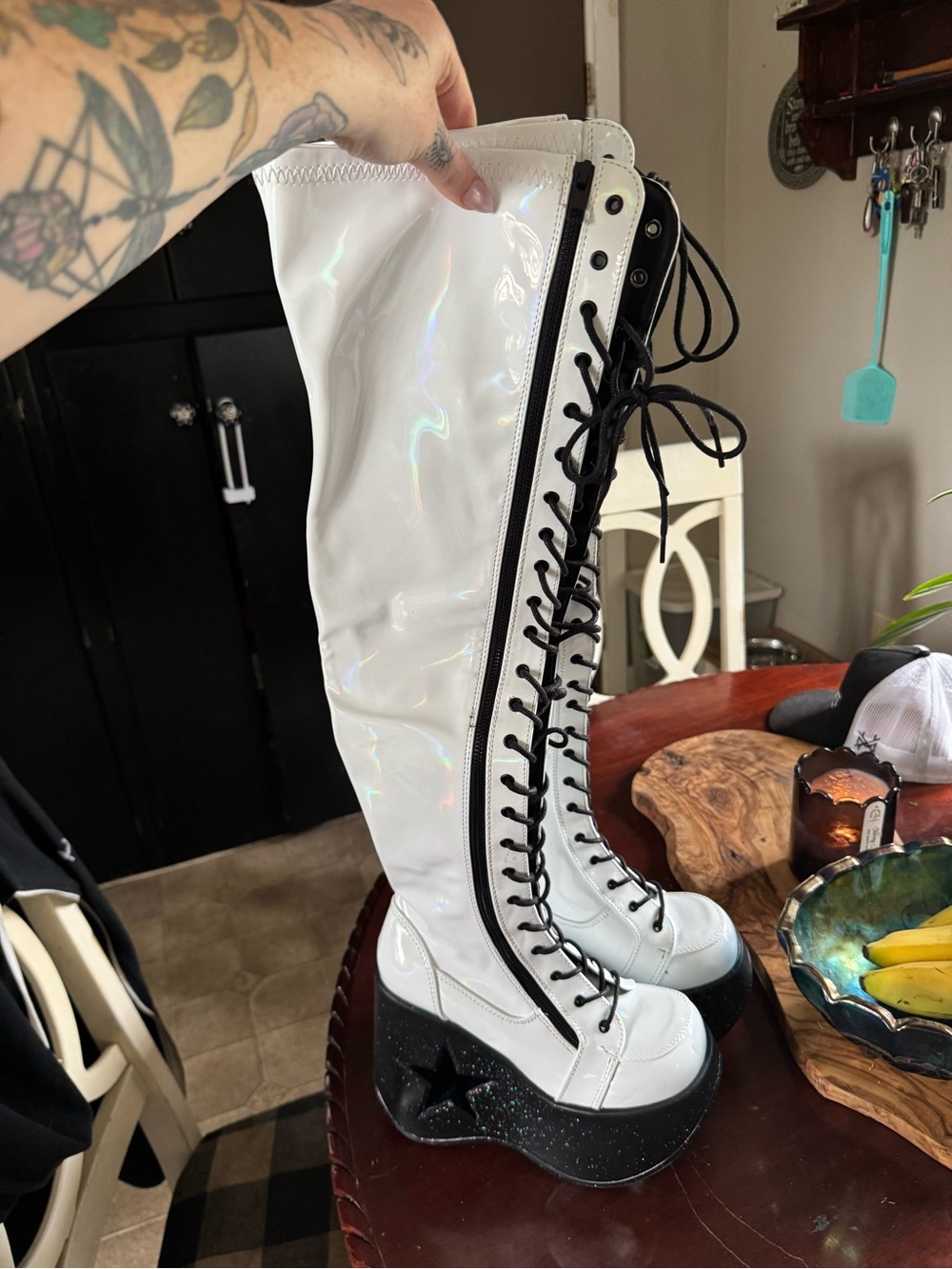 Demonia White Lace-Up Platform Knee-High Boots in holographic white.
